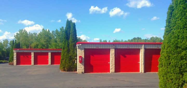 Image of storage units underneath a sky with puffy white clouds